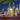Bar setup with bottles, a glass pitcher, and bar tools on a wooden surface.