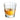 Clear glass filled with amber liquid on a white background