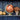 Copper globe on a shelf with decorative pumpkins and flowers against a blue wall.