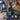 Decorative candles and containers on a wooden surface with a decorative background.
