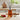 Reed scent diffuser on a kitchen counter with tomatoes and herbs.