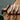 Set of four knives with wooden handles on a wooden cutting board.