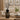Decorative 5 Litre Gourmand & Oriental Flower Reed Diffuser with black sticks on a wooden table in a living room.