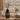 Decorative 5 Litre Gourmand & Oriental Flower Reed Diffuser with black sticks on a wooden table in a living room.