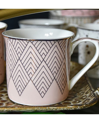 Pink and Gold Mug with a White Handle and Geometric Design