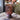 Brown textured glass lamp on a wooden surface with blurred background