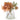 Chrysanthemum autumnal florals in glass vase with orange blooms and foliage