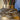 Decorative vase with gold accents and dried plants on a blurred background