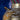 Close-up of a textured gold vase with a blurred background
