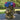Large antique-style lion head planter with a rustic gold finish, designed with a detailed mane, displayed on a wicker table and filled with vibrant blue, pink, and purple hydrangeas.