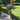 Floral arrangement in a rustic urn shaped planter on a patio with garden background