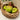 Woven basket with green apples on a light surface