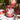 Candle with apple design on a table with other decorative items