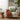 White armchair with a Rectangular Green Tassel Cushion and orange blanket in a cozy living room setting.