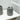 Ribbed grey toothbrush holder on bathroom shelf