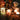 Decorative candles and tea lights on a table with a warm glow