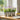 Metal garden planters with purple flowers on a kitchen windowsill