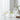 Clear glass tumblers with drinks on a white surface with a neutral background