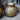 Decorative gold and silver textured vase on a neutral background