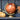 Copper globe on a dark wooden shelf with decorative pumpkins and flowers.