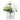 Artificial white hydrangeas in a clear glass cube vase with green leaves