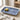 Rectangular blue and white patterned plate with olives and a fork on a light surface.