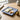 Blue and white patterned plate with sliced pears and apples on a wooden table.