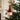 christmas decor: lifestyle view 1 of the 15cm santa hat paper tree decoration in red and white styled in a festive home setting