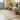 Nestled corner of a room with a floral arrangement, bench, and hallway runner