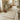 Hallway runner with a geometric pattern in a room with a table, flowers, and shoes.