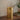 Gold decorative lantern on a wooden surface with a neutral background