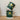 Two green mugs with lemon and leaf pattern stacked on a wooden surface.