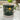 Dark green leaves and lemons-patterned mug with white handle, on white countertop