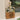 Decorative cutting board with floral pattern and wooden base against a neutral background