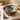 Wooden bowl with lemon and leaf pattern on a stone surface