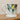 White mug with lemon and leaf design on a wooden surface