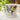 White mug with lemon and leaf design on a light surface