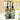 Two green glass bottles labeled 'Oil' and 'Vinegar' in a stand on a kitchen counter.