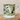 White mug with olive design on a wooden surface