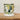 White mug with olive design on a wooden surface