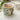 Mug with olive design filled with a beverage on a white surface.