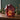 rechargeable lamp: lifestyle view 1 of the Red rechargeable led glass gingerbread house styled in a festive home setting