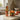 Orange home fragrance set on kitchen countertop, next to tomatoes, bowls and chopping boards.