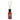 A room fragrance diffuser with amber-red liquid, natural wooden reeds, and a Highland cow illustration
