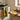 Two kitchen towels with tomato designs, one yellow and one green, laid out in kitchen.