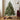 Small Christmas tree with wooden feet displayed beside wrapped Christmas presents