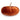 An orange pumpkin cushion on a white background