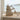 Decorative whale sculpture on a windowsill with a view of water outside