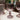 Set of three ribbed glass goblets on a white surface with a blurred background