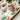 Two glasses of red liquid with berries on a floral-patterned tray.